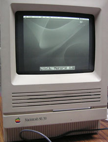 Mac OS X running on a Mac mini inside an SE/30