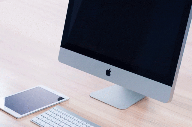 iMac and Tablet on wooden table