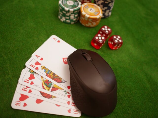Poker cards, chips, dice, and mouse